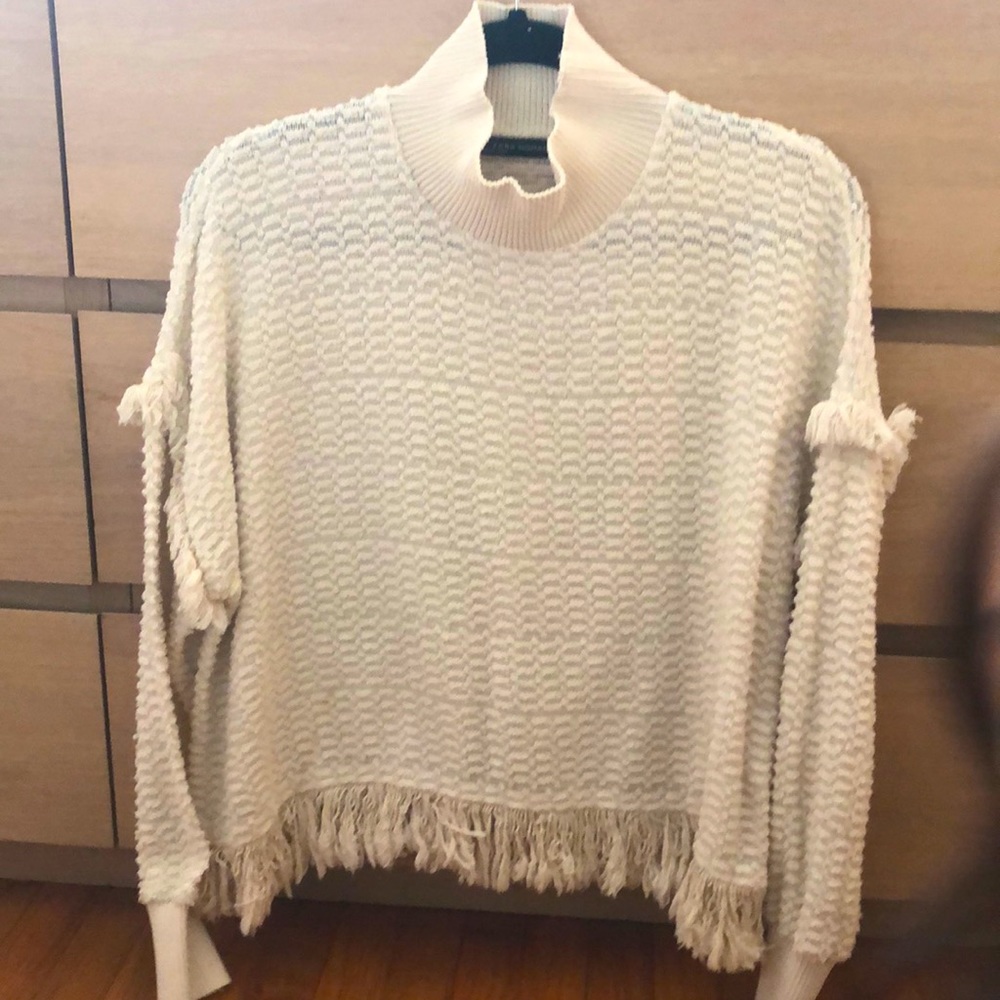 Cream colored boho pullover with fringe detail